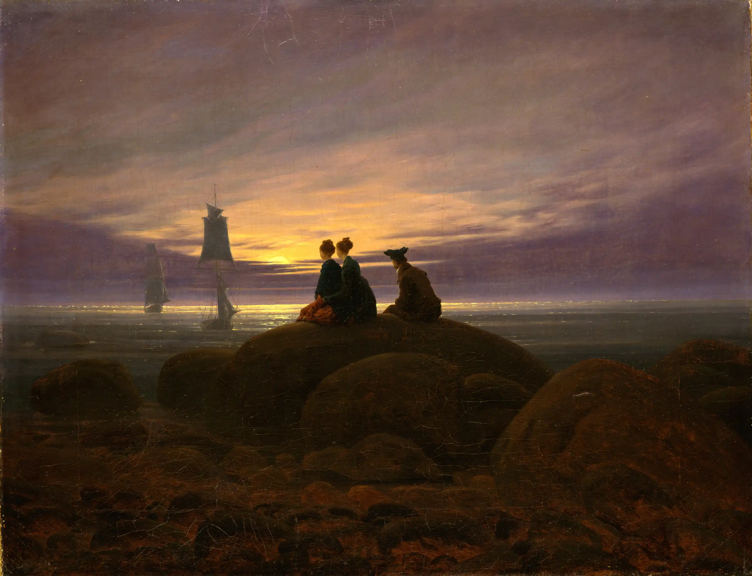 Gemälde von Caspar David Friedrich mit dem Titel „Mondaufgang am Meer“, gemalt im Jahr 1822. Das Bild zeigt eine Küstenlandschaft, im Vordergrund sitzen drei Menschen auf einem Felsen und schauen, uns abgewandt, in den farbenprächtigen Sonnenuntergang am Horizont.